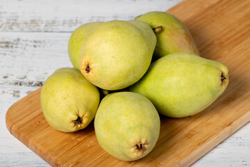 Fresh pears on a white wooden background. Organic agricultural products. Delicious ripe pears