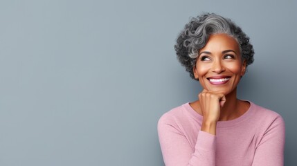 Fototapeta na wymiar portrait of a beautiful middle-aged African American woman with a short gray hairstyle on a plain pastel background
