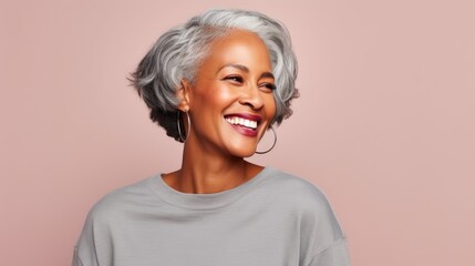 portrait of a beautiful middle-aged African American woman with a short gray hairstyle on a plain pastel background
