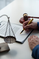 Consultant or lawyer and scales, hammer of justice read contract details before signing to check...