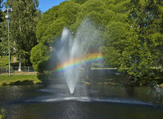 Fototapeta premium Rainbow in public park at the river Skellefteälven in Skelleftea, Sweden, Europe 