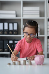 Saving money. Asian daughter wearing glasses plans to spend money in the future Family financial...