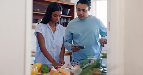 Cooking, recipe and phone of couple in a kitchen with communication and home together with food. Nutrition website, online blog and reading instruction for meal with people ready for eating lunch