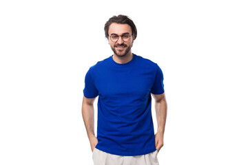 portrait of a young brunette man with a well-groomed beard dressed in a blue t-shirt on a white background with copy space