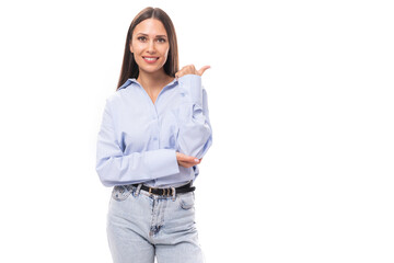 portrait of a young charming european business woman with long black hair dressed in a blue blouse on a white background with copy space