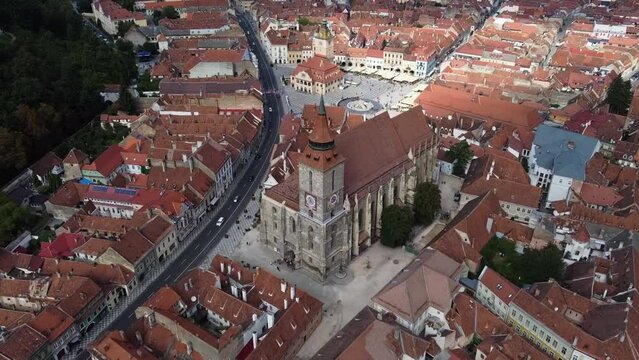 Forward drone towards black church near old city centre in Brasov, Romania
