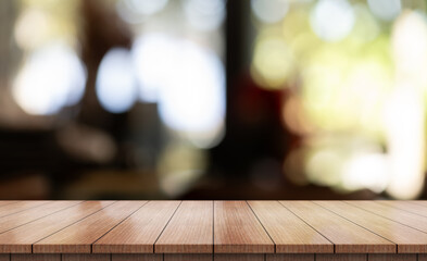 Empty wooden table top with lights bokeh on blur restaurant background.