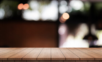 Empty wooden table top with lights bokeh on blur restaurant background.