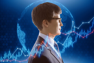 Portrait of attractive young european businessman with globe and candlestick forex chart....