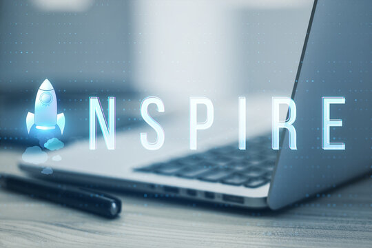 Close up of laptop and pen on desk with creative text and spaceship replacing letter on blurry background with bokeh circles. Think, idea, start up, creative and inspire concept. Toned image.
