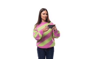 e-business concept. 35 year old feminine model woman dressed in pink and green pullover watches...