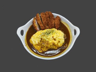 Close up top view of Japanese chicken katsu curry with egg on rice isolated on grey background.