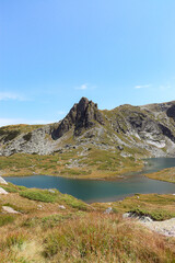 Haramiata Peak mountain view over the Twin Lake (Bliznaka) during the summer season at the Seven Rila Lakes tourist attraction near Sofia, Bulgaria