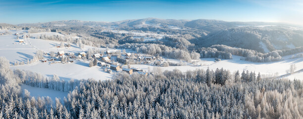 Aerial view to winter landscape. Snow-covered trees at sunny day. Lomy, Osečnice, Orlicke hory, Eagle Mountains