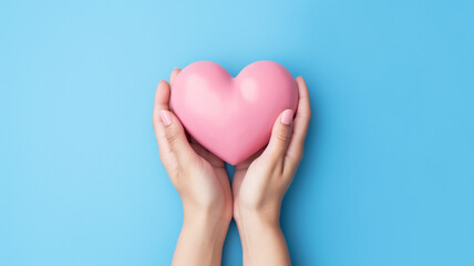 Heart in hands on a minimal background. Charity, health, care, love concept.