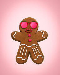 Cute happy gingerbread man in pink glassses on pink background. Minimal art card idea.