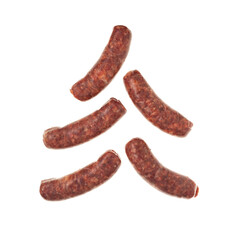 Raw sausages with paprika for barbecue grill on white background. Natural meat processed foods. Chorizo sausage lie in form alternative Christmas tree
