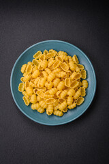 Raw durum wheat gnocchi pasta with salt and spices in a ceramic plate