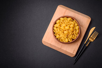 Raw durum wheat gnocchi pasta with salt and spices in a ceramic plate