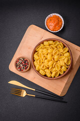 Raw durum wheat gnocchi pasta with salt and spices in a ceramic plate