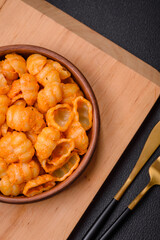Delicious fresh pasta with pesto sauce, salt, spices and herbs on a ceramic plate