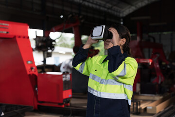 Fototapeta na wymiar Female engineer working technology virtual reality headset for control robot arm system welding at production plant factory