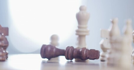 Person, hand and chess piece in defeat on board for king, checkmate or endgame on table at home. Closeup of people playing strategic match, challenge or victory in sports competition on chessboard