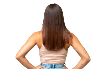 Naklejka premium Young caucasian woman isolated on green chroma background in back position