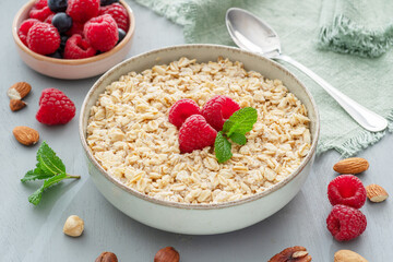 Bowl of porridge or oatmeal with fruits close up. Breakfast concept.