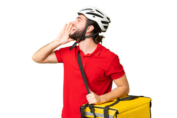 Young delivery man with thermal backpack over isolated chroma key background shouting with mouth wide open to the lateral