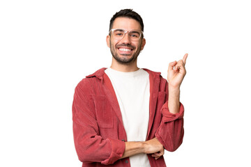Young handsome caucasian man over isolated chroma key background happy and pointing up