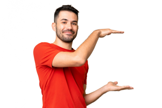Young handsome caucasian man over isolated chroma key background holding copyspace to insert an ad