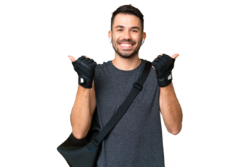 Young sport caucasian man with sport bag over over isolated chroma key background with thumbs up gesture and smiling