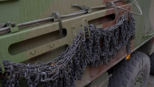 8x8 military transport vehicle with chains in downtown Riga, close up view