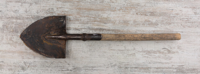 bayonet shovel on wooden background