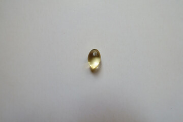 Closeup of one softgel capsule of vitamin D
