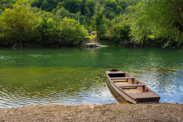 A wooden boat on the River Una north of Martin Brod, Bihac, in the Una National Park. Una-Sana Canton, Federation of Bosnia and Herzegovina. Early September