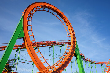 Close-up of a fun roller coaster ride. Extreme outdoor recreation.