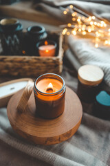 Burning candle in a festive cozy interior