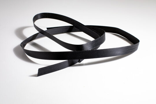 Nylon cord strap for industrial use isolated on white background, close up plastic poly strap for cargo box. Composite cord strapping belt for securing a transport