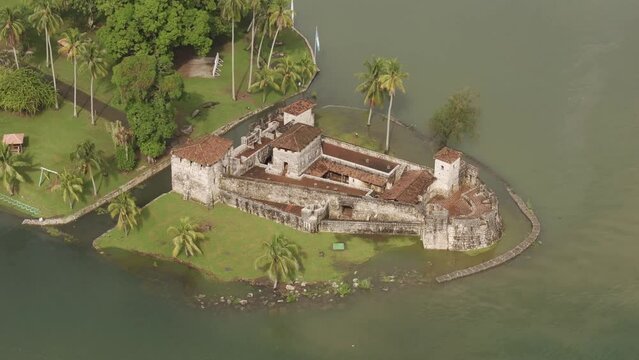 Side panning shot of medieval castle san felipe at Guatemala, aerial