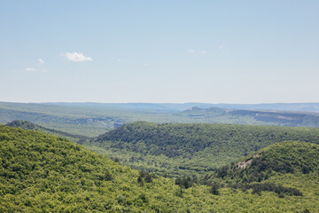 Naklejka premium Beautiful landscape of mountains, rocks, green forest and blue sky