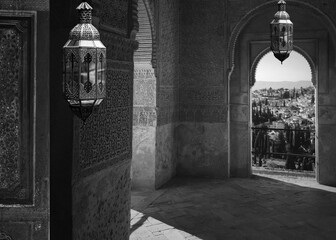 A black and white photo of a building with lights hanging from the ceiling . Ramadan. Social media...