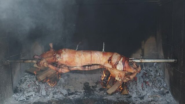 pig on a spit over coals on a barbecue