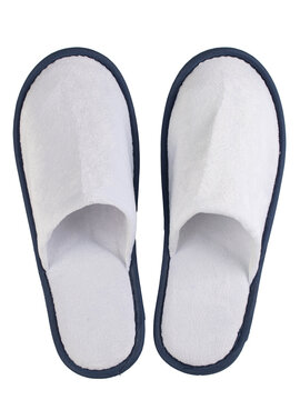 disposable hotel slippers made of white material with blue edging, isolated on a white background