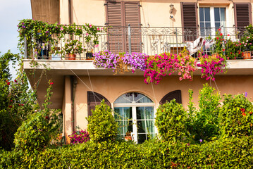 Fototapeta na wymiar House balcony decorated with colorful flowers