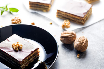 Gerbeaud Cake. Zserbo. Traditional Hungarian multi-layer cake with plum jam, nuts and covered with chocolate glaze