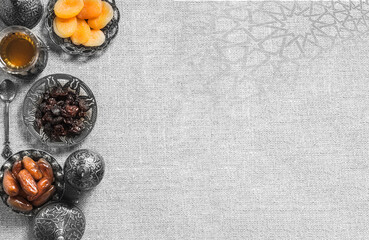 A black bowl of dried fruit on a gray background . .a background for Ramadan. Social media posts .Muslim Holy Month Ramadan Kareem .Ramadan Mubarak beautiful greeting card