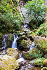 Fototapeta na wymiar travel to Georgia - water stream from Makhuntseti Waterfall in Adjara on autumn day