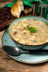 Traditional polish soup Zurek in ceramic bowl.
